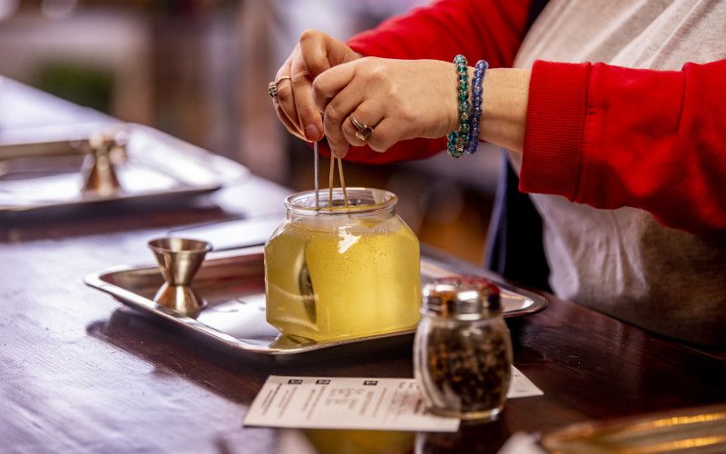 Candle wax being poured and set by a customer at Petals and Wicks