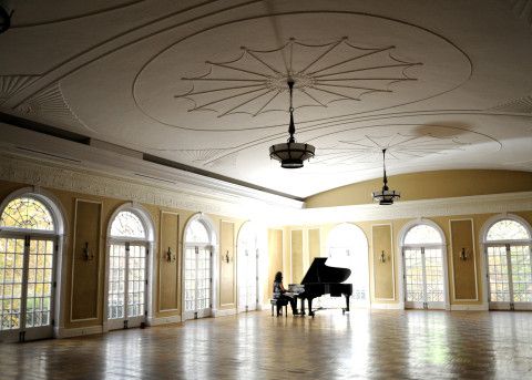 A piano in the ballroom at the Oxford Community Arts Center