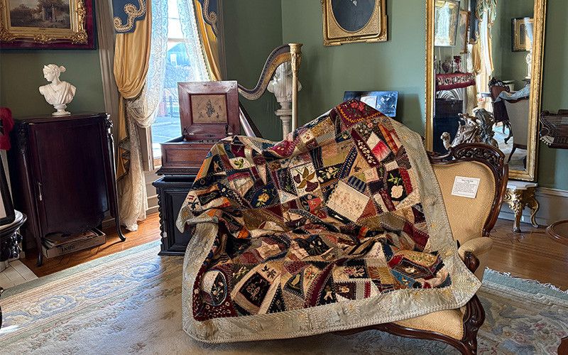 Quilt covering a chair on display in the Butler County Historical Society
