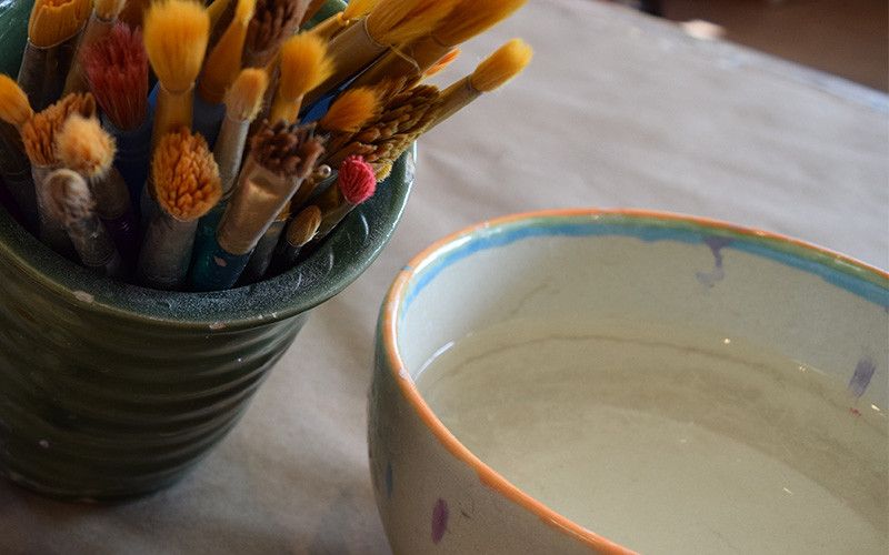 Paintbrushes and pottery at You're Fired pottery studio in Oxford